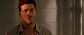 Movie still from “The Thirteenth Floor” (1999), directed by Josef Rusnak – A man that is staring at the camera; Close Up shot, Over the shoulder angle