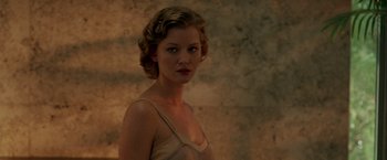 Movie still from “The Thirteenth Floor” (1999), directed by Josef Rusnak – A woman in a white dress standing next to a brick wall; Close Up shot, Over the shoulder angle