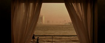 Movie still from “The Thirteenth Floor” (1999), directed by Josef Rusnak – Two people standing on a pier looking out over the water; Extreme Wide shot, High angle