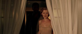 Movie still from “The Thirteenth Floor” (1999), directed by Josef Rusnak – A man and a woman standing in front of a window; Medium shot, Over the shoulder angle