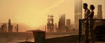 Movie still from “The Thirteenth Floor” (1999), directed by Josef Rusnak – A view of a city from the beach at sunset; Extreme Wide shot, High angle