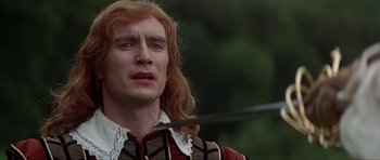 Movie still from “The Three Musketeers” (1993), directed by Stephen Herek – A person holding a sword in his hand; Close Up shot, Over the shoulder angle