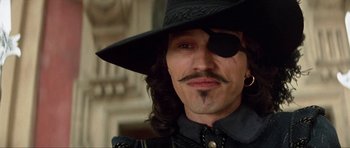 Movie still from “The Three Musketeers” (1993), directed by Stephen Herek – A person wearing a hat and eye patch; Close Up shot, Low angle