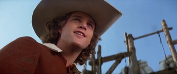 Movie still from “The Three Musketeers” (1993), directed by Stephen Herek – A person wearing a cowboy hat; Close Up shot, Low angle