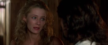 Movie still from “The Three Musketeers” (1993), directed by Stephen Herek – A young woman looking at a man in a dark room; Close Up shot, Over the shoulder angle