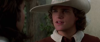 Movie still from “The Three Musketeers” (1993), directed by Stephen Herek – A person wearing a cowboy hat; Close Up shot, Over the shoulder angle