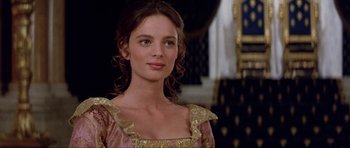 Movie still from “The Three Musketeers” (1993), directed by Stephen Herek – A beautiful young lady wearing a pink and gold dress; Close Up shot, Over the shoulder angle