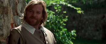 Movie still from “The Three Musketeers” (1993), directed by Stephen Herek – A person with long blond hair; Close Up shot, Over the shoulder angle