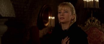 Movie still from “The Three Musketeers” (1993), directed by Stephen Herek – A woman standing in front of a mirror and candles; Close Up shot, Over the shoulder angle