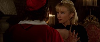 Movie still from “The Three Musketeers” (1993), directed by Stephen Herek – A woman in a red dress looking at a man in a red suit; Close Up shot, Over the shoulder angle