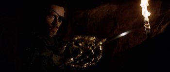 Movie still from “The Three Musketeers” (1993), directed by Stephen Herek – A man in a pirate costume holding a sword; Close Up shot, Over the shoulder angle