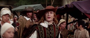 Movie still from “The Three Musketeers” (1993), directed by Stephen Herek – A man wearing a hat and a costume; Medium shot, Over the shoulder angle