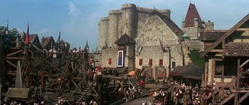 Movie still from “The Three Musketeers” (1993), directed by Stephen Herek – A crowd of people standing in front of a castle; Extreme Wide shot, Low angle