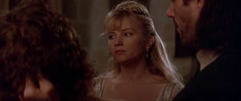 Movie still from “The Three Musketeers” (1993), directed by Stephen Herek – A woman with blonde hair wearing a white dress; Close Up shot, Over the shoulder angle