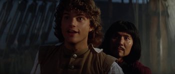 Movie still from “The Three Musketeers” (1993), directed by Stephen Herek – A man with a beard and a mustache and a man with long hair; Close Up shot, Over the shoulder angle