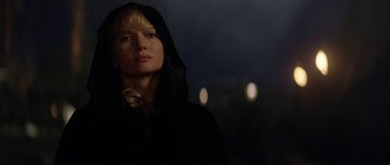 Movie still from “The Three Musketeers” (1993), directed by Stephen Herek – A woman wearing a hooded jacket standing in the dark; Close Up shot, Low angle