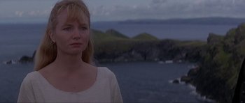 Movie still from “The Three Musketeers” (1993), directed by Stephen Herek – A woman standing in front of a body of water; Close Up shot, Low angle