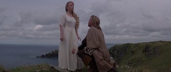 Movie still from “The Three Musketeers” (1993), directed by Stephen Herek – A man kneeling down next to a beautiful woman; Medium shot, Over the shoulder angle
