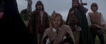 Movie still from “The Three Musketeers” (1993), directed by Stephen Herek – A group of men standing next to each other; Medium shot, Low angle