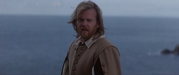 Movie still from “The Three Musketeers” (1993), directed by Stephen Herek – A person with long blond hair; Medium shot, Over the shoulder angle