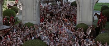 Movie still from “The Three Musketeers” (1993), directed by Stephen Herek – A large group of people standing in front of an archway; Extreme Wide shot, High angle