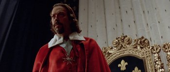 Movie still from “The Three Musketeers” (1993), directed by Stephen Herek – A person wearing a red robe; Close Up shot, Low angle