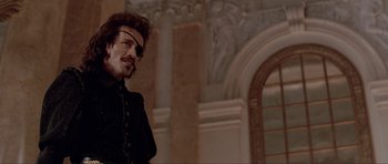 Movie still from “The Three Musketeers” (1993), directed by Stephen Herek – A person wearing a black shirt; Medium shot, Low angle