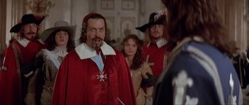 Movie still from “The Three Musketeers” (1993), directed by Stephen Herek – A group of people dressed in medieval clothing; Medium shot, Over the shoulder angle