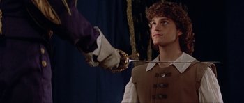 Movie still from “The Three Musketeers” (1993), directed by Stephen Herek – A man is holding a sword in front of another man; Close Up shot, Over the shoulder angle