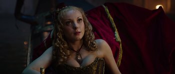 Movie still from “The Three Musketeers” (2011), directed by Paul W.S. Anderson – A woman with long blonde hair wearing a gold dress; Close Up shot, Low angle