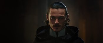 Movie still from “The Three Musketeers” (2011), directed by Paul W.S. Anderson – A person with long black hair; Close Up shot, Over the shoulder angle