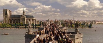 Movie still from “The Three Musketeers” (2011), directed by Paul W.S. Anderson – A group of people standing on top of a bridge; Extreme Wide shot, High angle