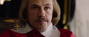 Movie still from “The Three Musketeers” (2011), directed by Paul W.S. Anderson – A person wearing a red shirt; Close Up shot, Over the shoulder angle