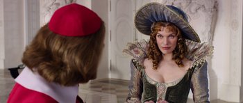 Movie still from “The Three Musketeers” (2011), directed by Paul W.S. Anderson – A woman in a medieval dress looking at another woman; Medium shot, Over the shoulder angle