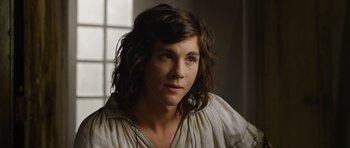 Movie still from “The Three Musketeers” (2011), directed by Paul W.S. Anderson – A woman with long brown hair wearing a white shirt; Close Up shot, Over the shoulder angle