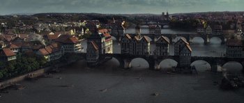 Movie still from “The Three Musketeers” (2011), directed by Paul W.S. Anderson – An aerial view of a city with a bridge and a river; Extreme Wide shot, High angle