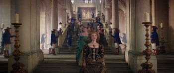 Movie still from “The Three Musketeers” (2011), directed by Paul W.S. Anderson – A group of people dressed in renaissance costumes; Wide shot, Low angle