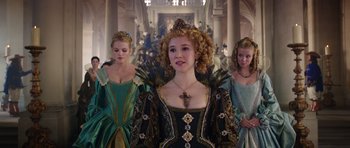 Movie still from “The Three Musketeers” (2011), directed by Paul W.S. Anderson – A group of women in renaissance costumes in a hallway; Medium shot, Over the shoulder angle