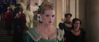 Movie still from “The Three Musketeers” (2011), directed by Paul W.S. Anderson – A beautiful young lady wearing a green dress; Close Up shot, Over the shoulder angle