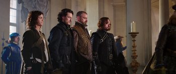 Movie still from “The Three Musketeers” (2011), directed by Paul W.S. Anderson – A group of men standing next to each other; Medium shot, Over the shoulder angle