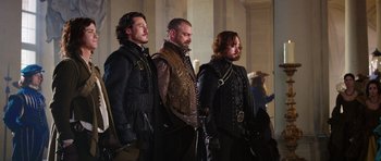 Movie still from “The Three Musketeers” (2011), directed by Paul W.S. Anderson – A group of men standing next to each other; Medium shot, Low angle