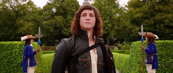 Movie still from “The Three Musketeers” (2011), directed by Paul W.S. Anderson – A man with long brown hair wearing a leather jacket; Medium shot, Low angle