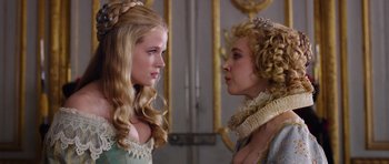 Movie still from “The Three Musketeers” (2011), directed by Paul W.S. Anderson – Two young women dressed in period clothing looking at each other; Close Up shot, Over the shoulder angle