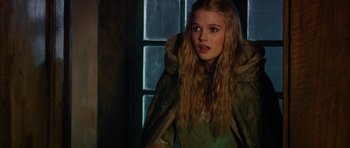 Movie still from “The Three Musketeers” (2011), directed by Paul W.S. Anderson – A young blonde haired woman wearing a green dress; Close Up shot, Over the shoulder angle