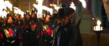 Movie still from “The Three Musketeers” (2011), directed by Paul W.S. Anderson – A group of people in costume in front of a crowd; Medium shot, Over the shoulder angle