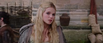 Movie still from “The Three Musketeers” (2011), directed by Paul W.S. Anderson – A beautiful young lady with long blonde hair and blue eyes; Close Up shot, Over the shoulder angle