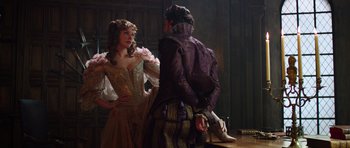 Movie still from “The Three Musketeers” (2011), directed by Paul W.S. Anderson – A man and a woman dressed in medieval clothing; Medium shot, Over the shoulder angle