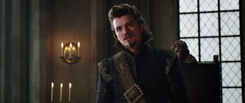 Movie still from “The Three Musketeers” (2011), directed by Paul W.S. Anderson – A man with a beard in a black and gold outfit; Close Up shot, Over the shoulder angle