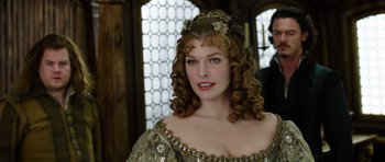 Movie still from “The Three Musketeers” (2011), directed by Paul W.S. Anderson – A woman with long hair and a tiara on her head; Close Up shot, Over the shoulder angle