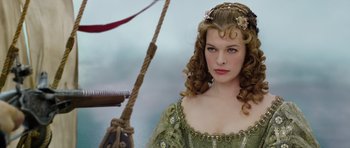 Movie still from “The Three Musketeers” (2011), directed by Paul W.S. Anderson – A beautiful young lady wearing a green dress; Close Up shot, Over the shoulder angle
